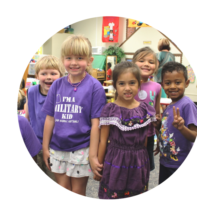 Children in a classroom wearing purple clothing.