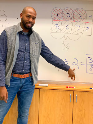 A teacher explaining a math problem.